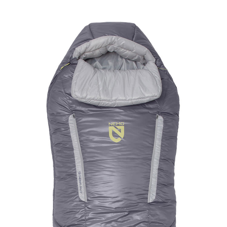 The NEMO Equipment Forte™ Endless Promise® Women's Synthetic Sleeping Bag is a gray and light gray 3-season bag with a hood, two front zippers, and the NEMO logo on the chest.